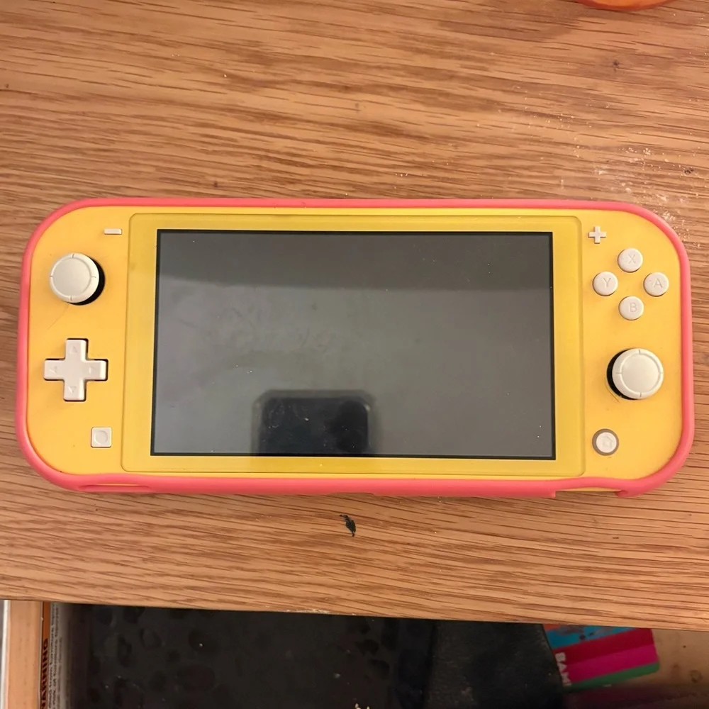 Yellow Nintendo Switch Lite (Comes with pink protective case)